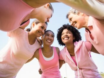 Women wearing pink for breast cancer with arms around in parkland Understanding Perimenopause Symptoms in Your 30s and 40s